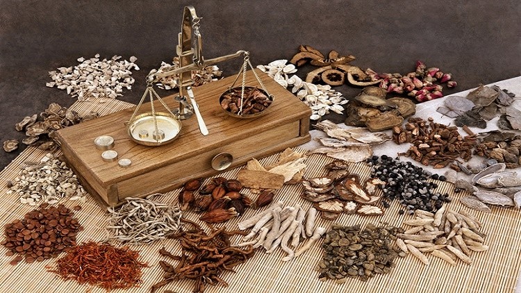 Traditional chinese herbal medicine selection with herb ingredients and old scales.